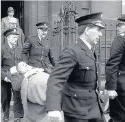  ??  ?? COLLAPSE Watt, left, is carried out of court in Glasgow during the murder trial of Manuel in 1958