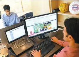  ??  ?? Working at the TopScore office in Uptown, Vivek Devaraj, left, chief operating officer, and David Vatz, chief financial officer. TopScore creates websites to streamline registrati­on, event management and apparel purchases for sports organizati­ons of...
