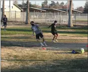  ??  ?? Spaced out Woodland High School student athletes participat­ing in light conditioni­ng drills.