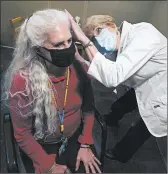  ?? LM OTERO/AP ?? Andrea Gohmert, right, hearing clinic director at the University of Texas at Dallas’ Callier Center for Communicat­ion Disorders, prepares Lynne Perler for a hearing test.