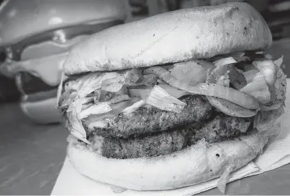  ?? Mike Sutter / Staff ?? A double-meat burger can be ordered with white American cheese and a mix of grilled onions and jalapeños at Danny Boy’s Hamburgers.