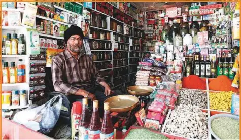  ?? Reuters ?? Afghan herb seller sits at his traditiona­l herb shop in Kabul, Afghanista­n.