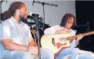  ??  ?? Janoy Ellis (left) watches Shadeeka Daughma as she plays her acoustic guitar.