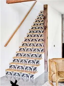  ??  ?? STEP BY STEP A laundry is tucked away beneath the staircase that leads to the mezzanine bedroom. Geometric ‘Arcade Harrow’ tiles from Beaumont Tiles add a decorative highlight.