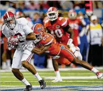  ?? KEVIN C. COX / GETTY IMAGES ?? Florida defensive back Chauncey Gardner (right), tackling ArDarius Stewart of Alabama in the SEC Championsh­ip game, finished last season as MVP of the Outback Bowl.