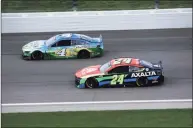  ?? Sean Gardner / Getty Images ?? Kevin Harvick, driver of the No. 4 Busch Light For The Farmers Ford, and William Byron race during the NASCAR Cup Series Buschy McBusch Race 400 at Kansas Speedway on May 2 in Kansas City, Kan.