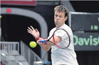  ?? JON BLACKER THE CANADIAN PRESS ?? Daniel Nestor, of Canada, returns a shot from the team of Matwe Middelkoop and Jean-Julien Rojer, of the Netherland­s, in Davis Cup doubles tennis action in Toronto on Sept. 15, 2018.