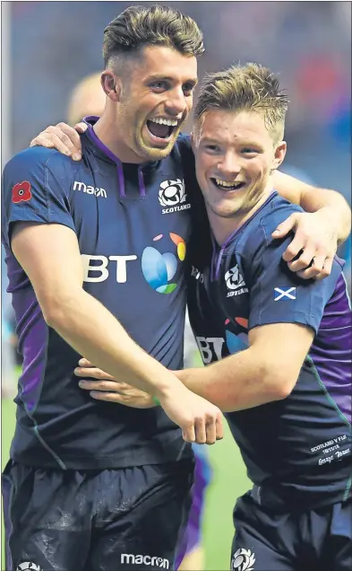  ??  ?? Adam Hastings and George Horne celebrate at Murrayfiel­d yesterday