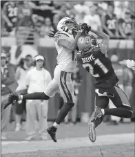  ?? AP/STEPHEN B. MORTON ?? Jacksonvil­le Jaguars cornerback A.J. Bouye (21) intercepts a pass intended for Los Angeles Chargers wide receiver Travis Benjamin during the Jaguars’ 20-17 overtime victory Sunday.