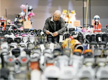  ??  ?? Tony Drago of Santa Fe looks for boots for his niece Friday at the Ski Swap at the Genoveva Chavez Community Center. The event is the annual fundraiser for the Santa Fe Ski Team. The swap continues Saturday with free admission.