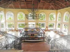  ??  ?? At the Majestic Colonial in the Dominican Republic, a grand staircase leads from the lobby to the main floor where a mahogany bar, topped with stained glass, makes cocktails each evening.