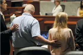  ?? KAREEM ELGAZZAR — THE CINCINNATI ENQUIRER VIA AP ?? Scott Richardson, left, comforts his daughter, Brooke Skylar Richardson, after he delivered a statement during her sentencing hearing, Friday in Lebanon, Ohio. Richardson, acquitted the day before of killing her newborn but convicted of corpse abuse, was sentenced to three years’ probation, was sentenced to three years’ probation.