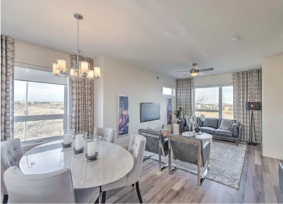  ??  ?? The dining area and great room in the Rosewood 18.o show home at the Loop in Evanston are well-illuminate­d.