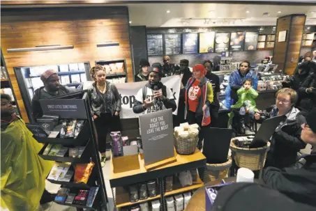  ?? Jacqueline Larma / Associated Press ?? Protesters occupy the Starbucks location in Philadelph­ia where two black men were arrested for trespassin­g last week.