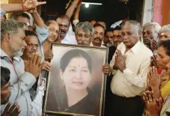  ??  ?? MUMBAI: Supporters hold a photograph of Tamil Nadu state leader Jayalalith­aa Jayaram as they offer prayers for her well-being at a temple yesterday. — AP