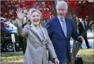  ?? SETH WENIG - THE ASSOCIATED PRESS ?? In this 2016 file photo, then-Democratic presidenti­al candidate Hillary Clinton, and her husband former President Bill Clinton, greet supporters after voting in Chappaqua, N.Y. The FBI is investigat­ing allegation­s of corruption connected to the Clinton...