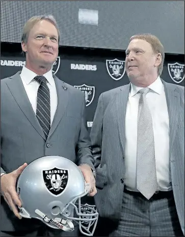  ?? GETTY IMAGES ?? Raiders new head coach Jon Gruden (left) and owner Mark Davis pose for a photograph during a news conference in Alameda, Calif., yesterday. Gruden returns after leaving the team in 2001.