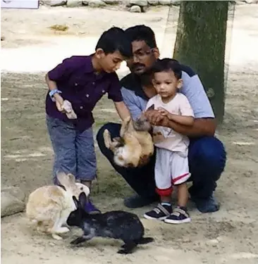  ??  ?? Natural instincts: The writer with his two happy ‘rangers’, Vissnu Viveganath­an and his younger brother Vidhur, at the Langkawi Wildlife Park, Kedah, in January last year.