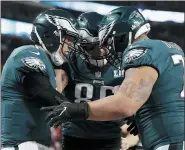  ?? THE ASSOCIATED PRESS ?? Philadelph­ia Eagles quarterbac­k Nick Foles, left, celebrate a touchdown with tight end Zach Ertz (86) and offensive guard Brandon Brooks (79), during the first half of the NFL Super Bowl 52football game against the New England Patriots, Sunday, Feb. 4, 2018, in Minneapoli­s.