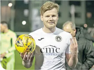  ??  ?? Edinburgh City’s Blair Henderson with the match ball after his hat-trick