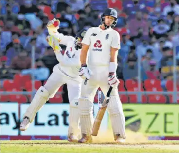  ?? BCCI ?? India keeper Rishabh Pant gathers an Axar Patel delivery that surprised Joe Root by kicking up from length on Day 2 of the third Test in Ahmedabad.