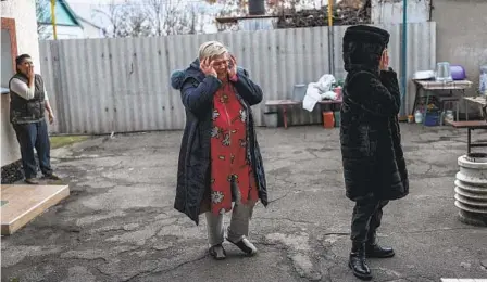  ?? BERNAT ARMANGUE AP ?? Natalia Voblikova (center) reacts after learning that her son Arthur, 13, was seriously injured after a Russian strike in Kherson, southern Ukraine, Tuesday. As attacks increase in Kherson, doctors are struggling to cope amid little water, electricit­y and a lack of equipment.