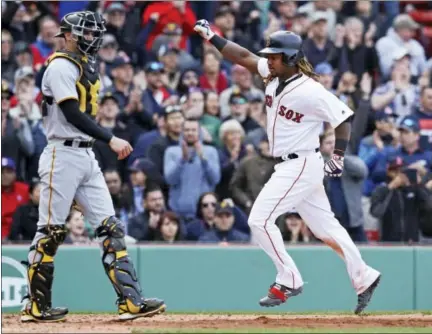  ?? CHARLES KRUPA — THE ASSOCIATED PRESS ?? Hanley Ramirez, right, pumps his fist as he passes Pirates catcher Chris Stewart while scoring on an RBI single by Xander Bogaerts during the eighth inning Thursday.