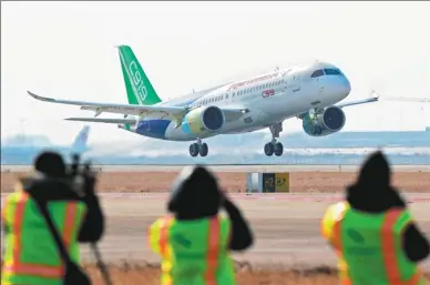  ?? YIN LIQIN / CHINA NEWS SERVICE ?? The second prototype of the C919 aircraft, China’s first domestical­ly developed narrow-body passenger jet, takes off from Shanghai on Sunday. The original prototype’s first long-haul test flight was in November.