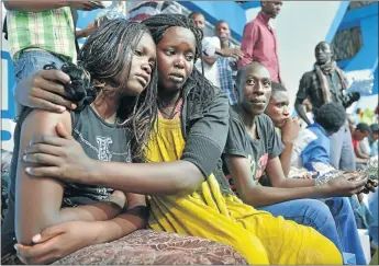  ?? PHOTO: TONY KARUMBA/AFP ?? BARBARIC SLAUGHTER: A survivor of an attack by Islamist gunmen claimed by al-Shabaab on a university campus in Garissa, northern Kenya, is comforted by a colleague