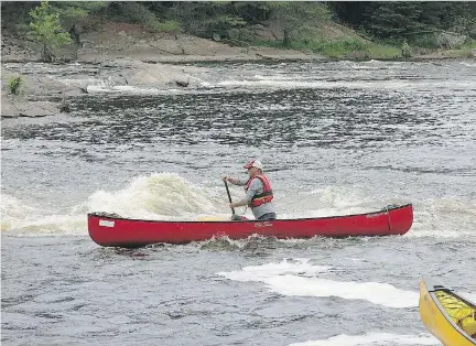  ??  ?? Archie Smith paddles on the swift- flowing Madawaska River during his annual white- water clinic.