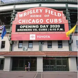  ?? ASHLEE REZIN GARCIA/SUN-TIMES ?? LEFT: Fans walk by closed gates at Wrigley Field before the Cubs’ game Friday.