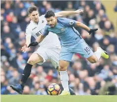  ??  ?? Manchester City’s Sergio Aguero in action with Swansea City’s Federico Fernandez on Feb 5 file photo. — Reuters photo