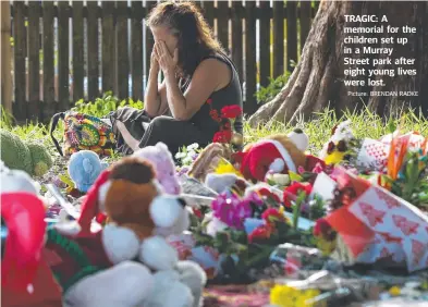  ??  ?? Picture: BRENDAN RADKE TRAGIC: A memorial for the children set up in a Murray Street park after eight young lives were lost.