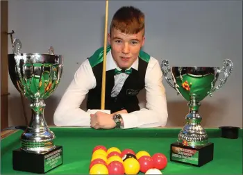  ??  ?? Newtown native Jordan Synnott pictured in Breakers Snooker Club in Gorey with his cups.