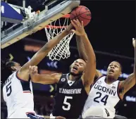  ?? Noah K. Murray / Associated Press ?? St. Bonaventur­e’s Jaren Holmes, center, drives to the basket against UConn’s Isaiah Whaley, left, and Jordan Hawkins on Saturday.