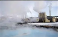  ?? EGILL BJARNASON — THE ASSOCIATED PRESS ?? In this photo taken on large clouds of steam rise into the sky from the Svartsengi geothermal power station in Grindav’k, Iceland. With massive amounts of energy needed to obtain bitcoins, large cryptocurr­ency mining companies have establishe­d a base...