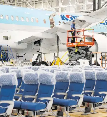  ?? RYAN REMIORZ/THE CANADIAN PRESS ?? A Bombardier employee works on a CSeries 300 jet Thursday. The company is accused of breaking trade rules by receiving substantia­l subsidies.