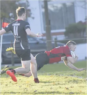  ??  ?? Touchdown Rab Cairns goes over to score for the Reds (Pic: Graham Black)