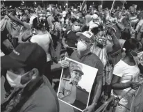  ?? REUTERS ?? A man holds an image of Cuba’s former President and First Secretary of the Communist Party Raul Castro during a rally amid concerns about the spread of the coronaviru­s disease in Havana, Cuba.