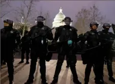  ?? Tasos Katopodis/Getty Images ?? Police officers in riot gear line up outside the U.S. Capitol on Jan. 6.