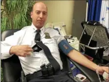  ?? NICHOLAS BUONANNO — NBUONANNO@TROYRECORD.COM ?? Troy Police Chief Brian Owens shows off his O-Positive blood type on his police uniform Tuesday afternoon, before donating blood to the Red Cross in Troy.