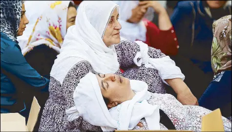  ?? REUTERS ?? Women mourn as they wait in front of a hospital morgue after a bomber targeted a wedding celebratio­n in Turkey yesterday.