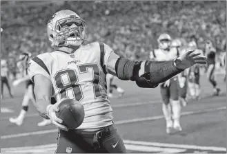  ?? KEITH SRAKOCIC/AP PHOTO ?? Patriots tight end Rob Gronkowski (87) celebrates a touchdown catch in a game against the Steelers on Dec. 17 at Pittsburgh.