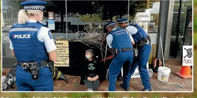  ?? MARTIN DE RUYTER/STUFF ?? Police arrest an Extinction Rebellion protester outside Nelson City Council’s main offices, during a demonstrat­ion over the council’s use of the herbicide glyphosate.