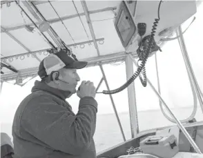  ?? DALE BOWMAN/SUN-TIMES ?? Capt. Bob Poteshman at the wheel of the Massive Confusion last summer on Lake Michigan. Poteshman is one of the last full-time charter captains in Chicago.