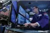  ?? RICHARD DREW - THE AP ?? Specialist Patrick King works at his post on the floor of the New York Stock Exchange, Friday. Stocks are off to a mostly lower start on Wall Street Friday, though gains for some big technology companies are sending the Nasdaq a bit higher.