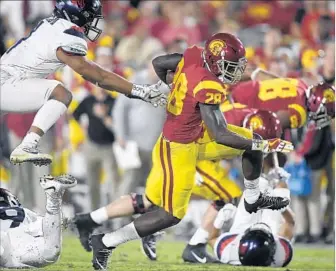  ?? Mark J. Terrill Associated Press ?? USC’S Aca’Cedric Ware was one of the Trojans picking up big yardage on the ground in last week’s victory over Arizona. The Trojans ran the ball twice as many times as they passed in that game.