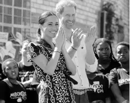  ?? AP ?? Britain’s Prince Harry and Meghan, Duchess of Sussex, greet youths on a visit to the Nyanga Methodist Church in Cape Town, South Africa, which houses a project where children are taught about their rights, selfawaren­ess and safety, and are provided self-defence classes and female empowermen­t training to young girls in the community.