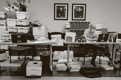  ?? Photos by Kin Man Hui / Staff photograph­er ?? Paralegal Jose Medellin works at a makeshift desk in a training room on Tuesday while a section of the Bexar County District Attorney’s Office and at least two courtrooms affected by water damage are awaiting renovation­s.