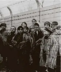  ?? Associated Press file photo ?? Children are liberated from Auschwitz, where 1.1. million people were killed, in 1945. Still, today, people need reminding